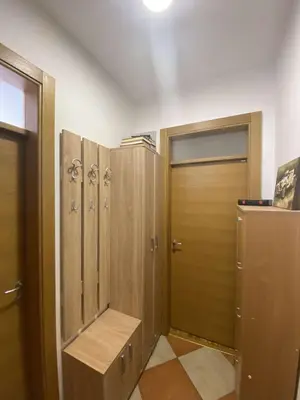 a locker room with wooden lockers and a door at Pico apartments in Ulcinj