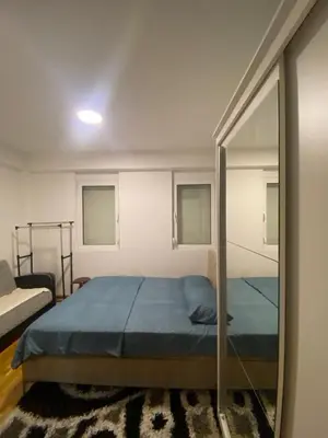 a bedroom with a bed and a mirror at Pico apartments in Ulcinj