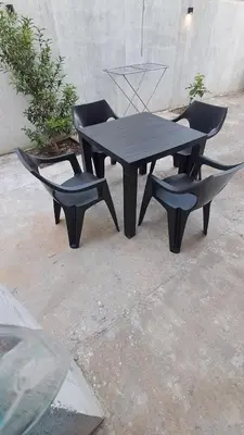 a black table and two chairs and a table and chairs at B&L Apartmani in Sutomore