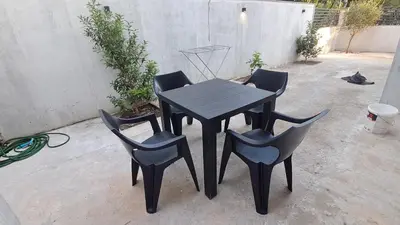 a black table and four chairs on a patio at B&L Apartmani in Sutomore
