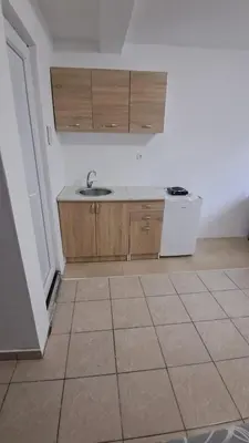 a kitchen with a sink and a tiled floor at B&L Apartmani in Sutomore