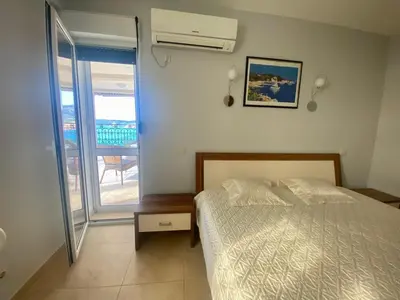a bedroom with a bed and a view of a balcony at Villa Maja in Sutomore