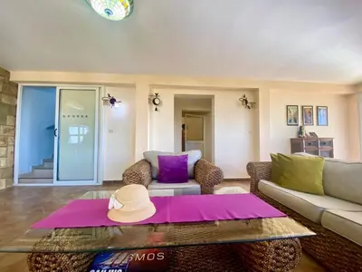 a living room with a couch and a hat on a table at Villa Maja in Sutomore
