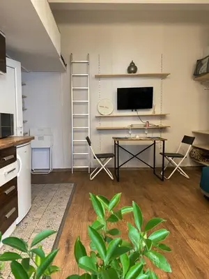 a living room with a table and a television at Lucky Space 2 Nice&Cozy Studio in Budva