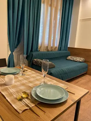a table with two plates and wine glasses on it at Lucky Space 2 Nice&Cozy Studio in Budva