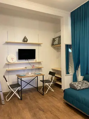a living room with a table and a tv at Lucky Space 2 Nice&Cozy Studio in Budva