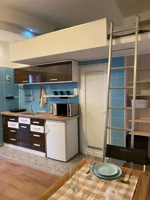 a kitchen with blue walls and a table with wine glasses at Lucky Space 2 Nice&Cozy Studio in Budva