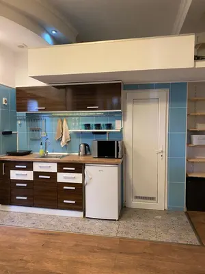 a kitchen with blue walls and a white refrigerator at Lucky Space 2 Nice&Cozy Studio in Budva