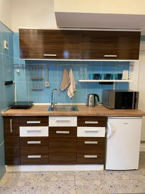 a kitchen with wooden cabinets and a sink at Lucky Space 2 Nice&Cozy Studio in Budva