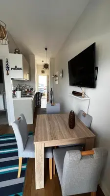 a living room with a wooden table and chairs at Casa Montenegro Lux Apartment 1 Bedroom 1 livingroom Sea & Pool View in Tivat