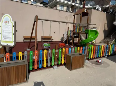 a playground with a colorful fence and a slide at Casa Montenegro Lux Apartment 1 Bedroom 1 livingroom Sea & Pool View in Tivat