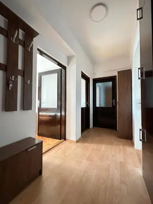 an empty room with a large door and wooden floors at Cozy one-bedroom apartment in the city center in Bar