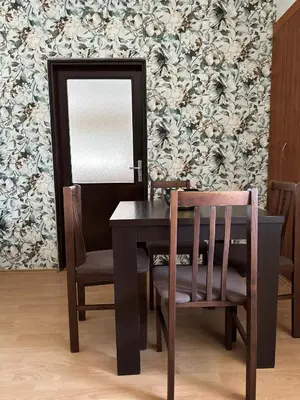 a dining room with a table and chairs and a mirror at Cozy one-bedroom apartment in the city center in Bar