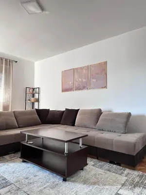 a living room with a brown couch and a coffee table at Cozy one-bedroom apartment in the city center in Bar