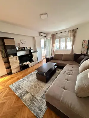 a living room with a couch and a coffee table at Cozy one-bedroom apartment in the city center in Bar