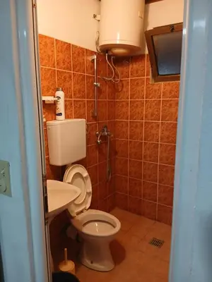a bathroom with a toilet and a sink at Apartmani OAZA 2 in Ulcinj