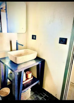 a bathroom with a sink on a wooden table at Cottage REE in Ulcinj