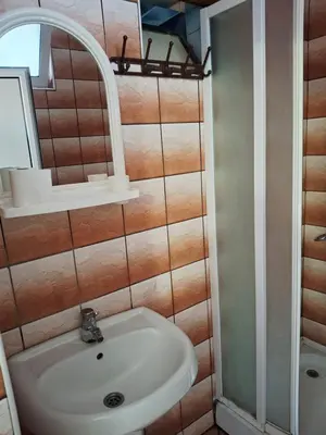 a bathroom with a sink and a mirror at Apartman Oaza 1 in Ulcinj
