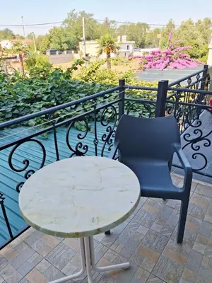 a table and a chair on a balcony at Apartman Oaza 1 in Ulcinj