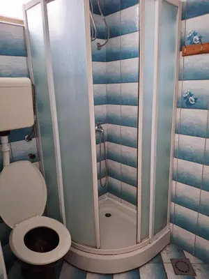 a small bathroom with a toilet and a shower at Apartman OAZA 3 in Ulcinj