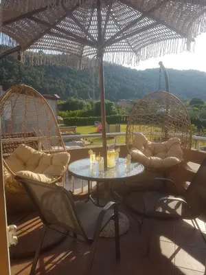 a patio with two chairs and a table and swings at Apartments Sofia in Bar