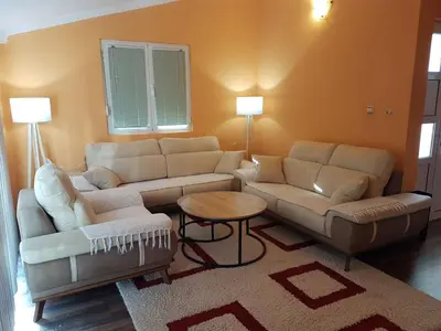 a living room with two couches and a table at Apartments Sofia in Bar