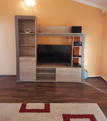 a entertainment center with a flat screen tv in a living room at Apartments Sofia in Bar