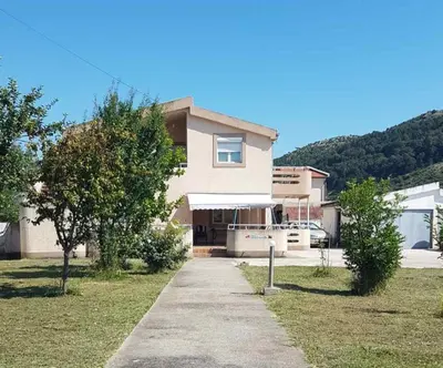 a house with a sidewalk in front of it at Apartments Sofia in Bar