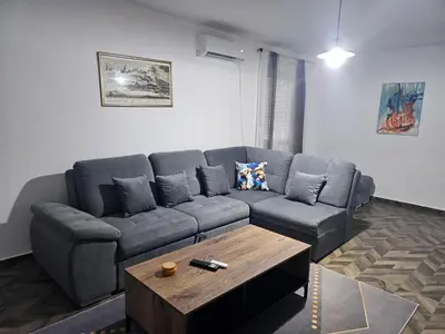 a living room with a couch and a coffee table at Apartman Mateo in Cetinje