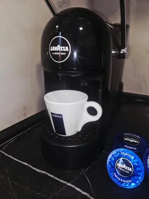 a coffee maker with a coffee cup on a counter at Apartman Mateo in Cetinje