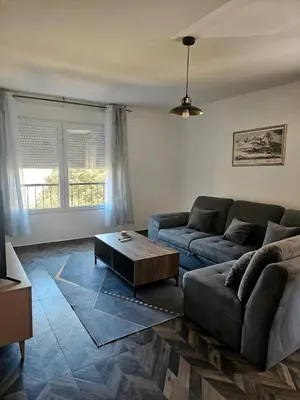 a living room with a couch and a coffee table at Apartman Mateo in Cetinje