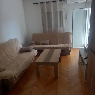 a living room with a couch and a coffee table at Apartman Stella in Budva