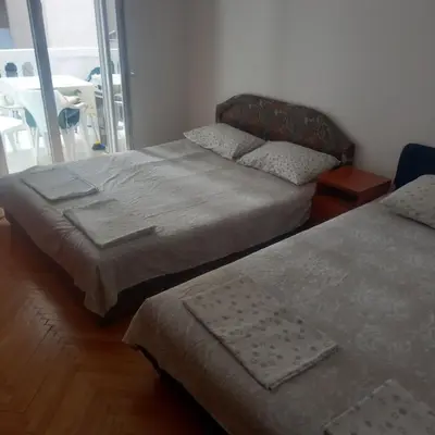 two beds sitting next to each other in a bedroom at Apartman Stella in Budva
