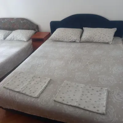 a bed with two pillows on it in a room at Apartman Stella in Budva