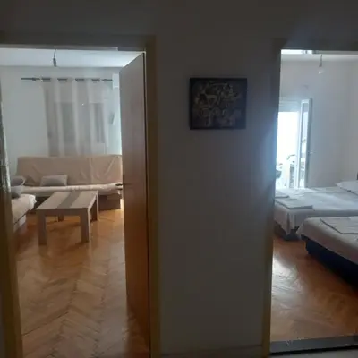 a room with a living room with a couch and a table at Apartman Stella in Budva