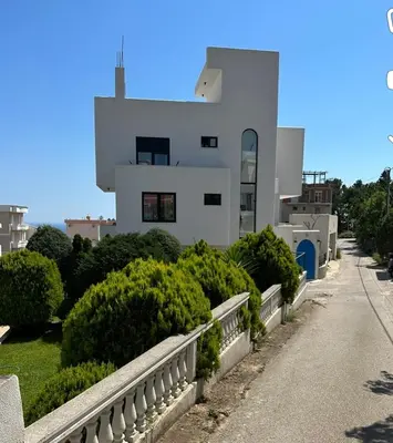 a white house with a fence in front of it at Carpe Diem 1 in Ulcinj