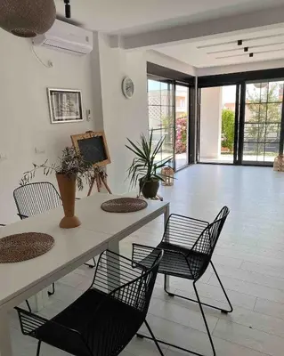 a living room with a table and chairs at Carpe Diem 1 in Ulcinj