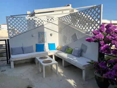 a white bench sitting on top of a patio at Carpe Diem 1 in Ulcinj