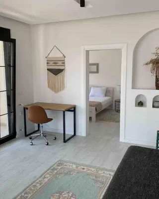a room with a desk and a bedroom with a bed at Carpe Diem 1 in Ulcinj