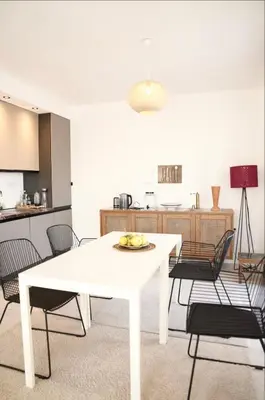 a white table and chairs in a room with a kitchen at Carpe Diem 1 in Ulcinj