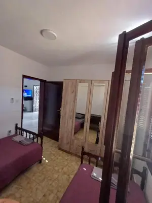 a room with a bed and mirrors in a room at Apartmani Reef House in Sutomore