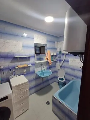 a bathroom with a tub and a toilet and a sink at Apartmani Reef House in Sutomore
