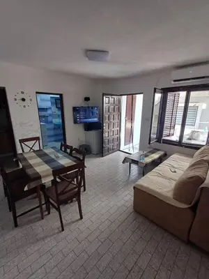 a living room with a table and a couch at Apartmani Reef House in Sutomore