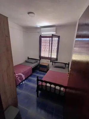 a room with two beds and a window at Apartmani Reef House in Sutomore
