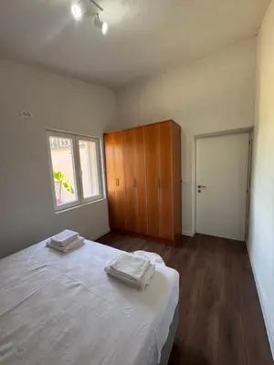 a bedroom with a bed with two towels on it at Rajkovic Stay Bukovik in Bukovik