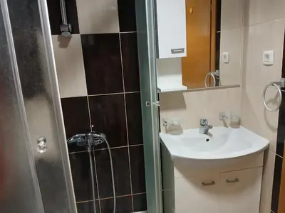 a small bathroom with a sink and a shower at Apartment EVA in Budva - 55 m2 in Budva