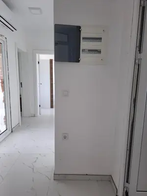a white refrigerator with a microwave on a wall at Vila stockholm in Donji Štoj