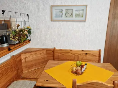 a table with a bowl of fruit on a yellow napkin at Apartman Draga Sutomore in Sutomore