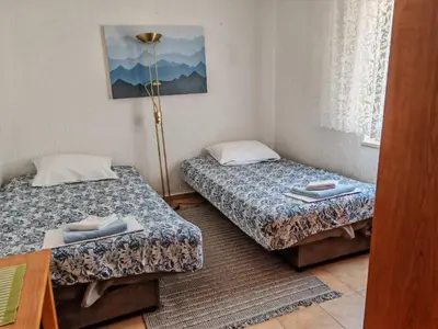 a room with two beds and a lamp in it at Apartman Draga Sutomore in Sutomore