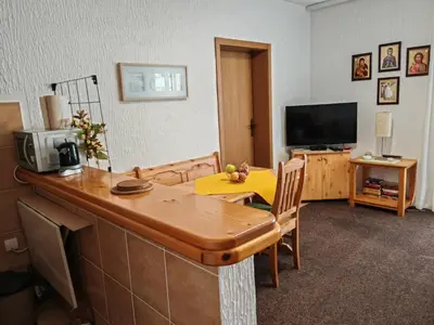 a living room with a table and a television at Apartman Draga Sutomore in Sutomore